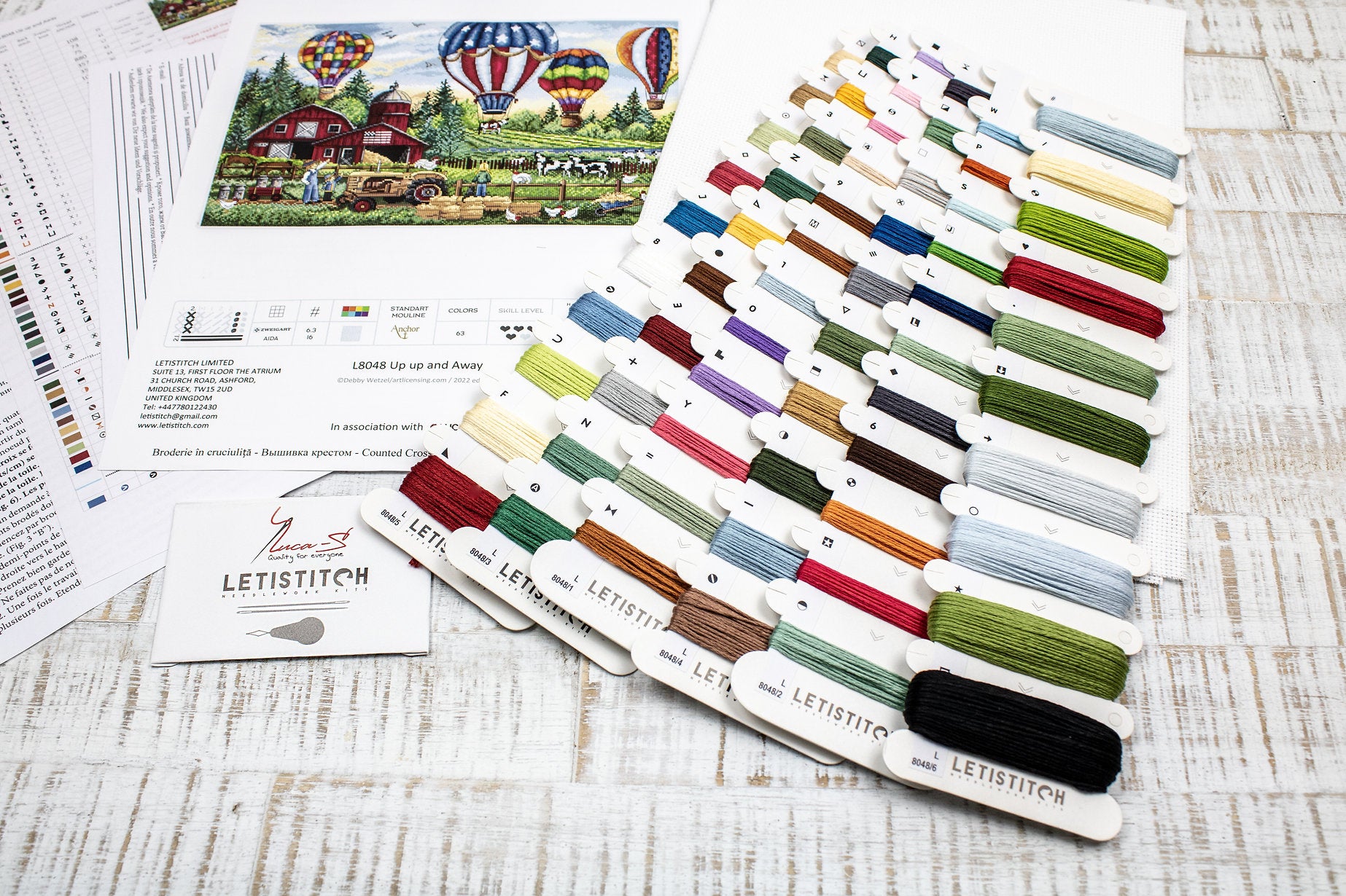 Up Up and Away L8048 Counted Cross Stitch Kit featuring colorful threads, Aida canvas, and detailed instruction chart.